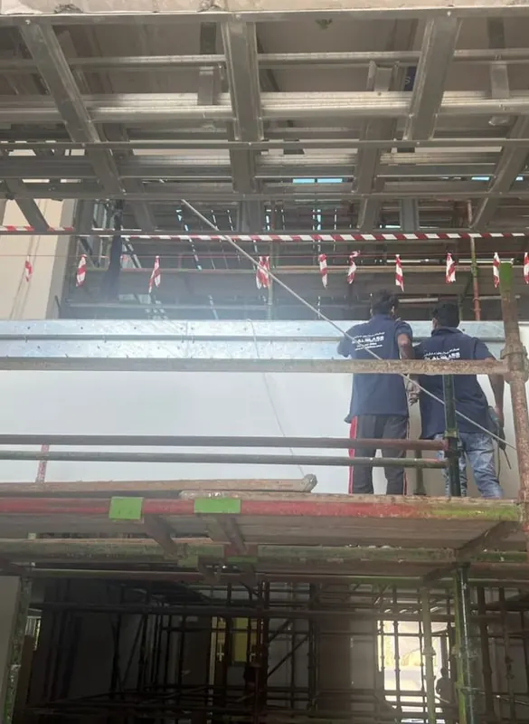 Glass installation in progress around an internal void on a villa in Al Barsha