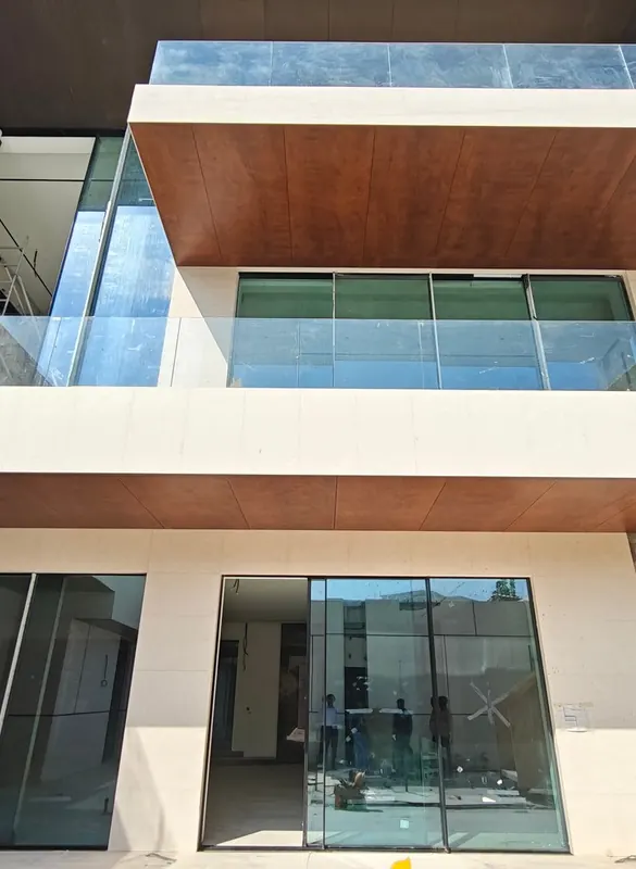 Balcony glazing beneath a timber-look soffit on Villa P-28 in Dubai Hills