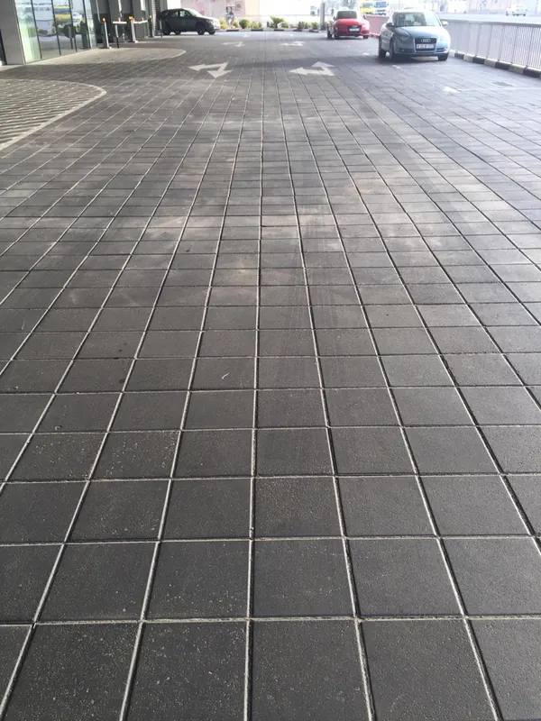 Audi service centre entrance interlock paving after rectification, level uniform finish with road markings